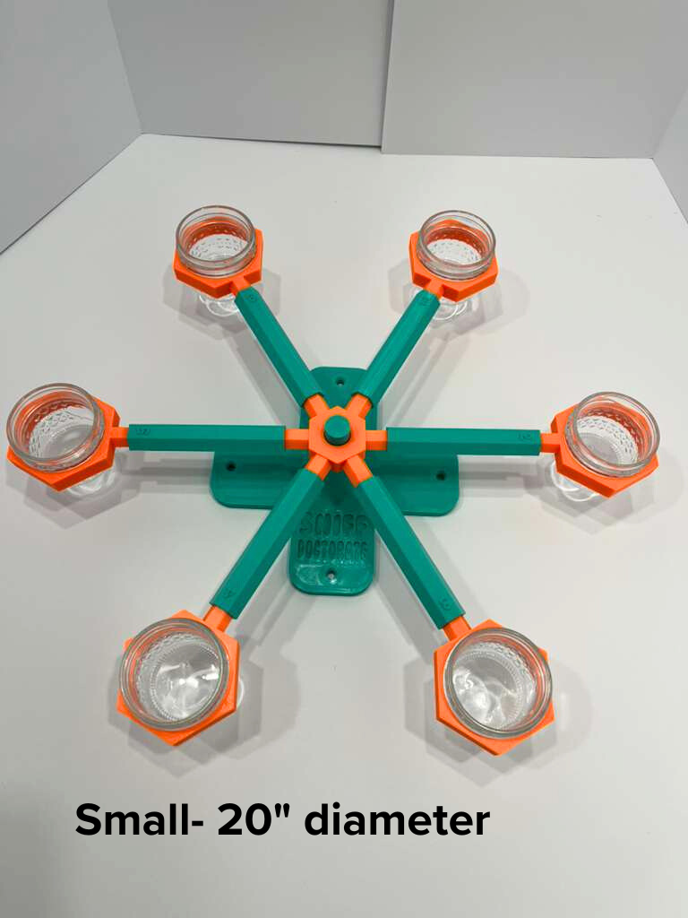 small 20-inch diameter scent wheel with bright orange scent cup holders and rotating spinners on a sturdy teal base and arms, built for professional detection dogs, AKC scent work trials, etc. scent cup holders have 4 oz glass jars for target odor. This photo is shown for size, is not wheel that is for sale