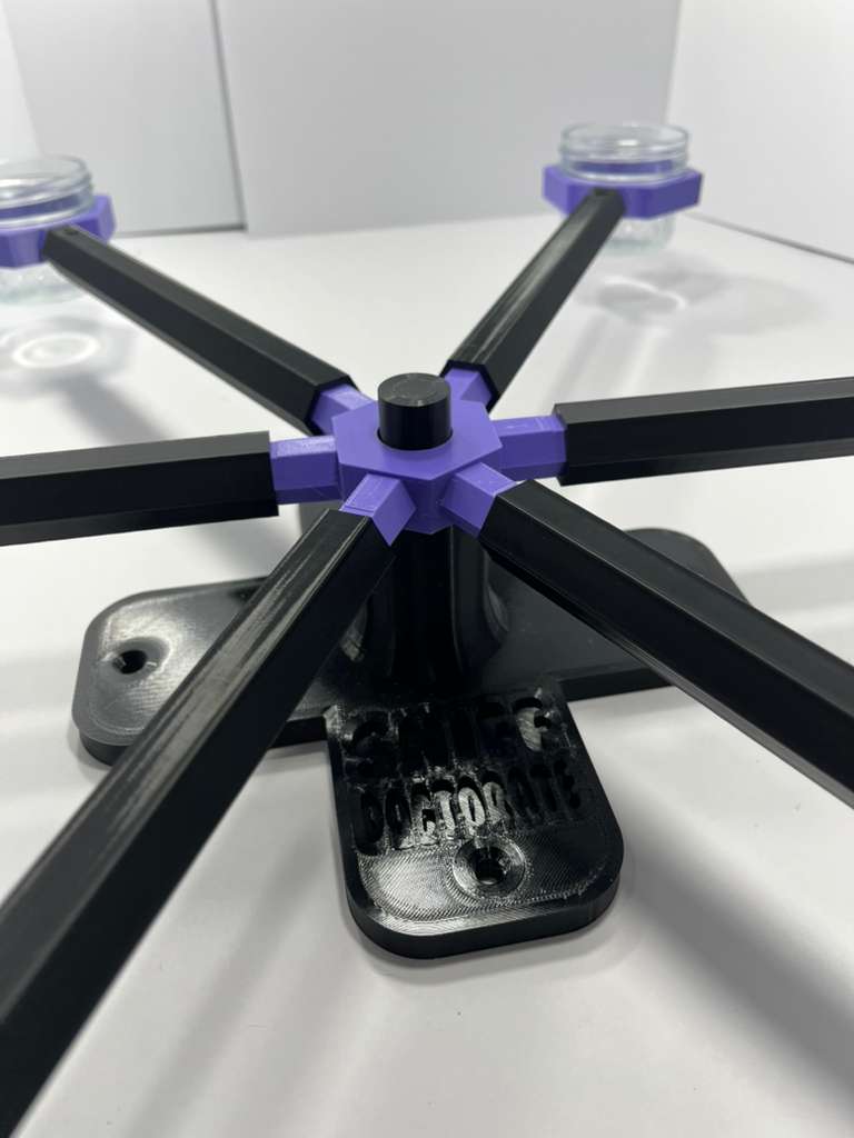 Scent wheel with lavender purple scent cup holders and rotating spinners on a sturdy black base and arms, built for professional detection dogs, AKC scent work trials, etc. scent cup holders have 4 oz glass jars for target odor. 