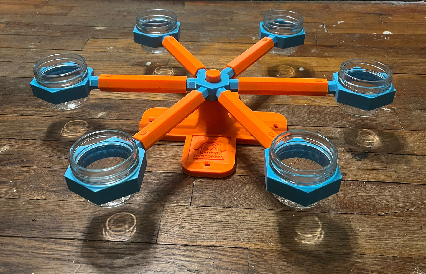 Orange and blue small scent wheel, shown assembled at a different angle. Diameter is 19" and height is 2.5". There are holes in the base to use decking screws to mount wheel higher. 