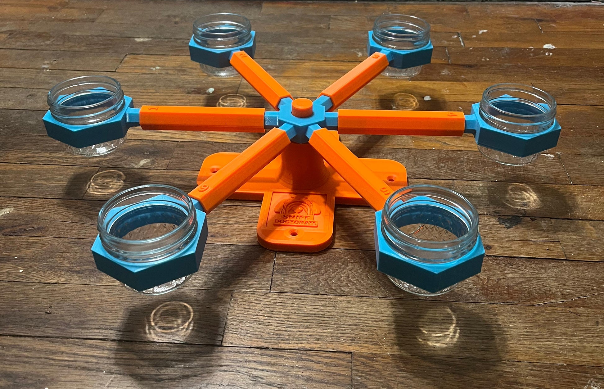 Orange and blue small scent wheel, shown assembled at a different angle. Diameter is 19" and height is 2.5". There are holes in the base to use decking screws to mount wheel higher. 