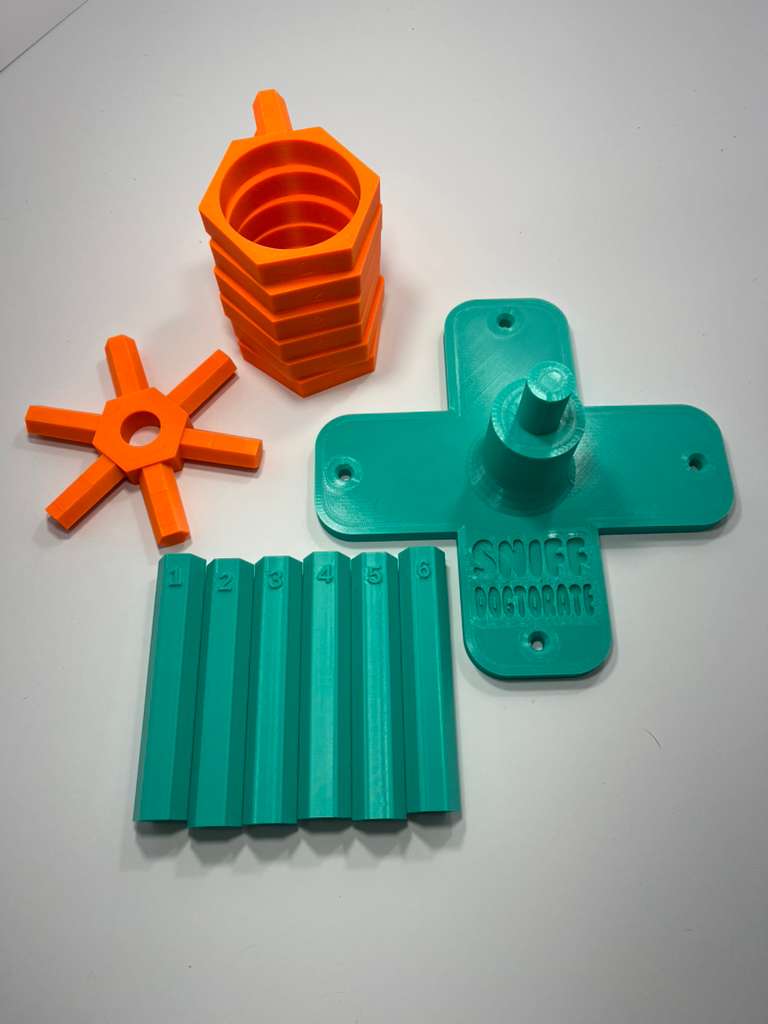 Scent wheel with bright orange scent cup holders and rotating spinners with a sturdy teal base and arms, built for professional detection dogs, AKC scent work trials, etc. scent cup holders have 4 oz glass jars for target odor. Photo shows scent wheel taken apart, with the base, spinner, 6 cup holders, 6 arms number 1-6