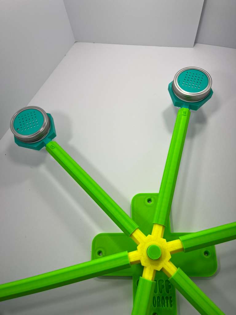 Large scent wheel with bright green base and arms, mint green glass cup holders, and a bright yellow spinner with mint green scent cup covers