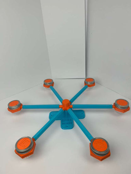 Large scent wheel with sky blue base and arms, sunny orange spinner, topper, cup covers, and cup holders
