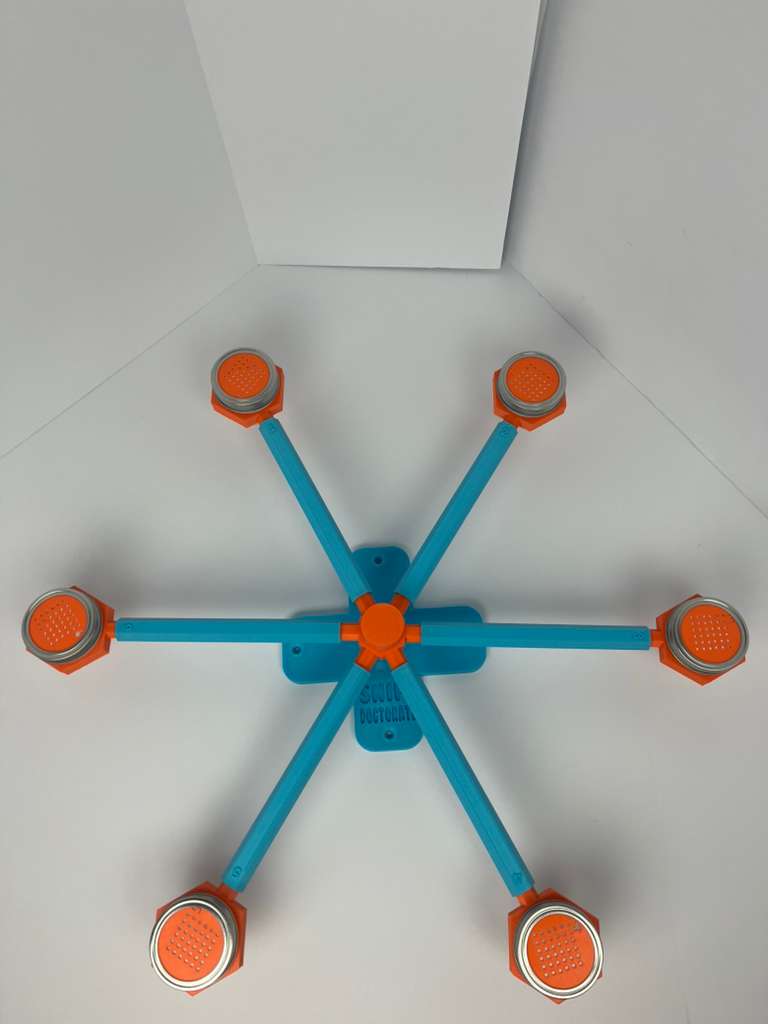 Large scent wheel with sky blue base and arms, sunny orange spinner, topper, cup covers, and cup holders