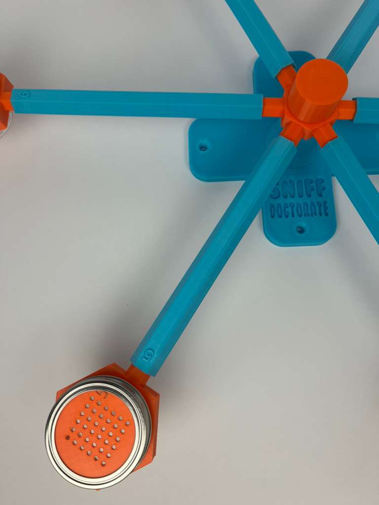 Large scent wheel with sky blue base and arms, sunny orange spinner, topper, cup covers, and cup holders