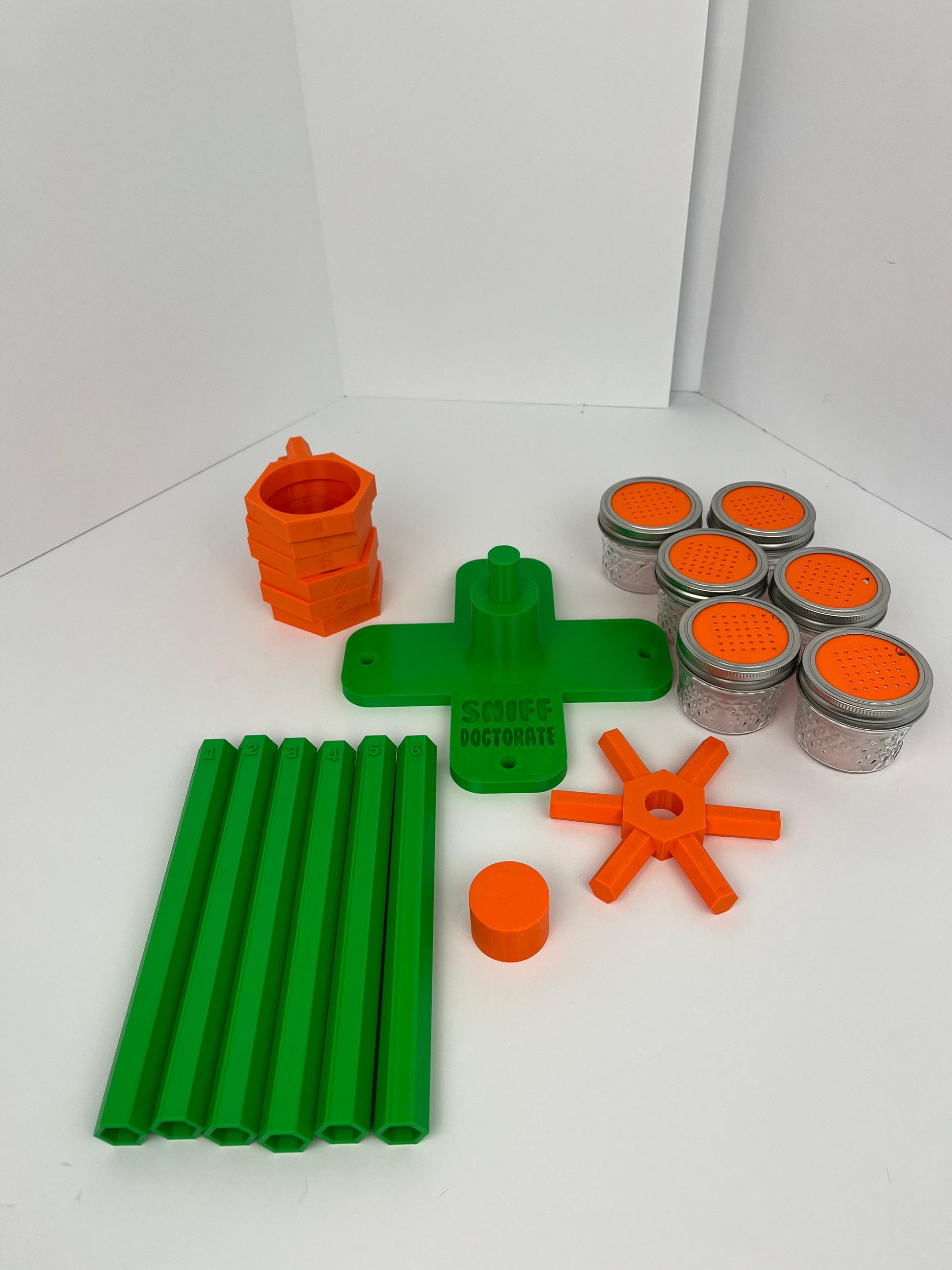 Large scent wheel with green base and arms, sunny orange spinner, topper, cup covers, and cup holders