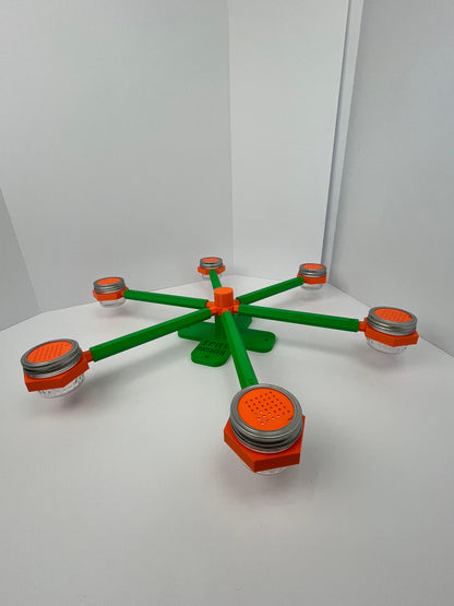 Large scent wheel with green base and arms, sunny orange spinner, topper, cup covers, and cup holders