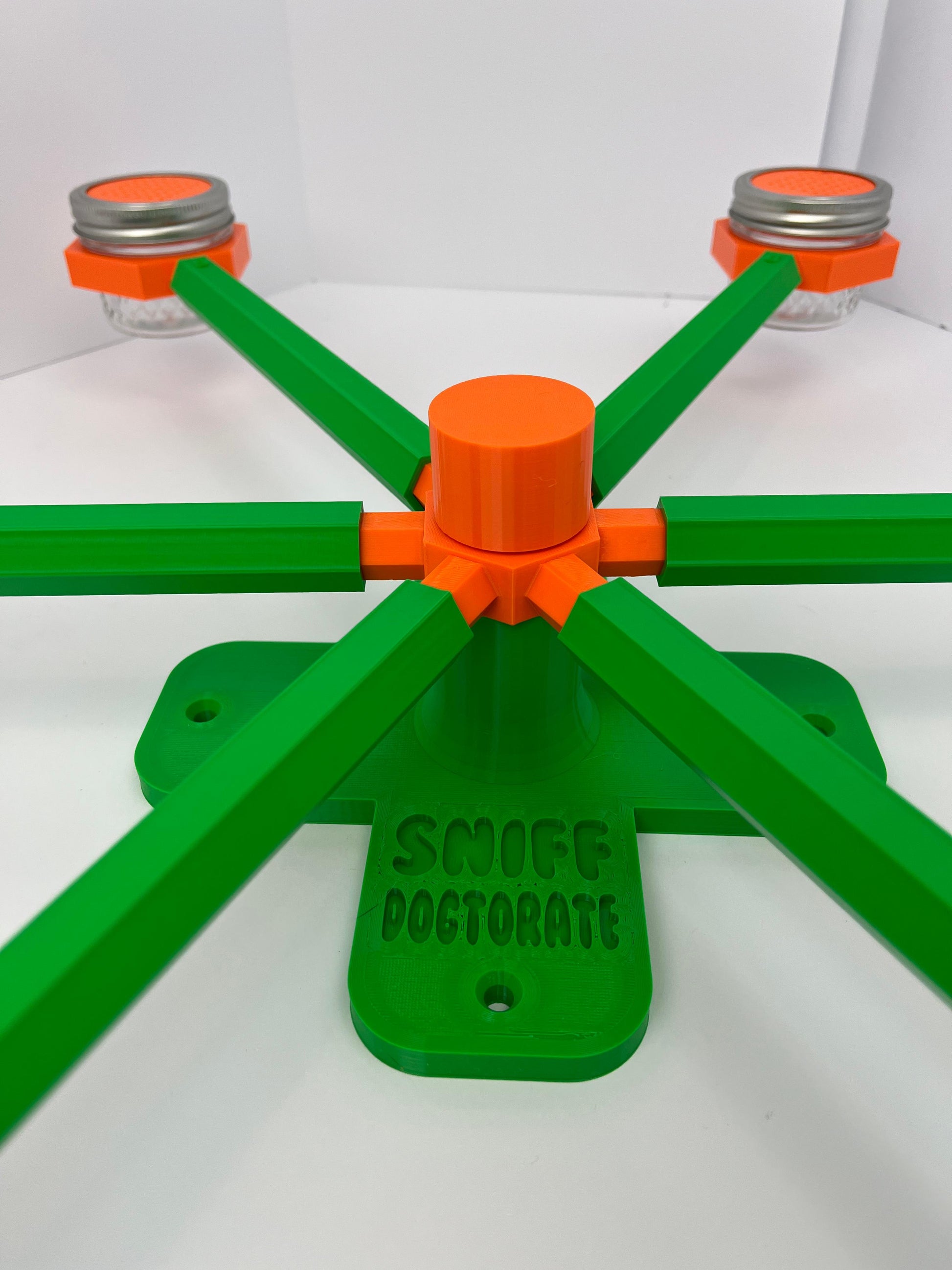 Large scent wheel with green base and arms, sunny orange spinner, topper, cup covers, and cup holders