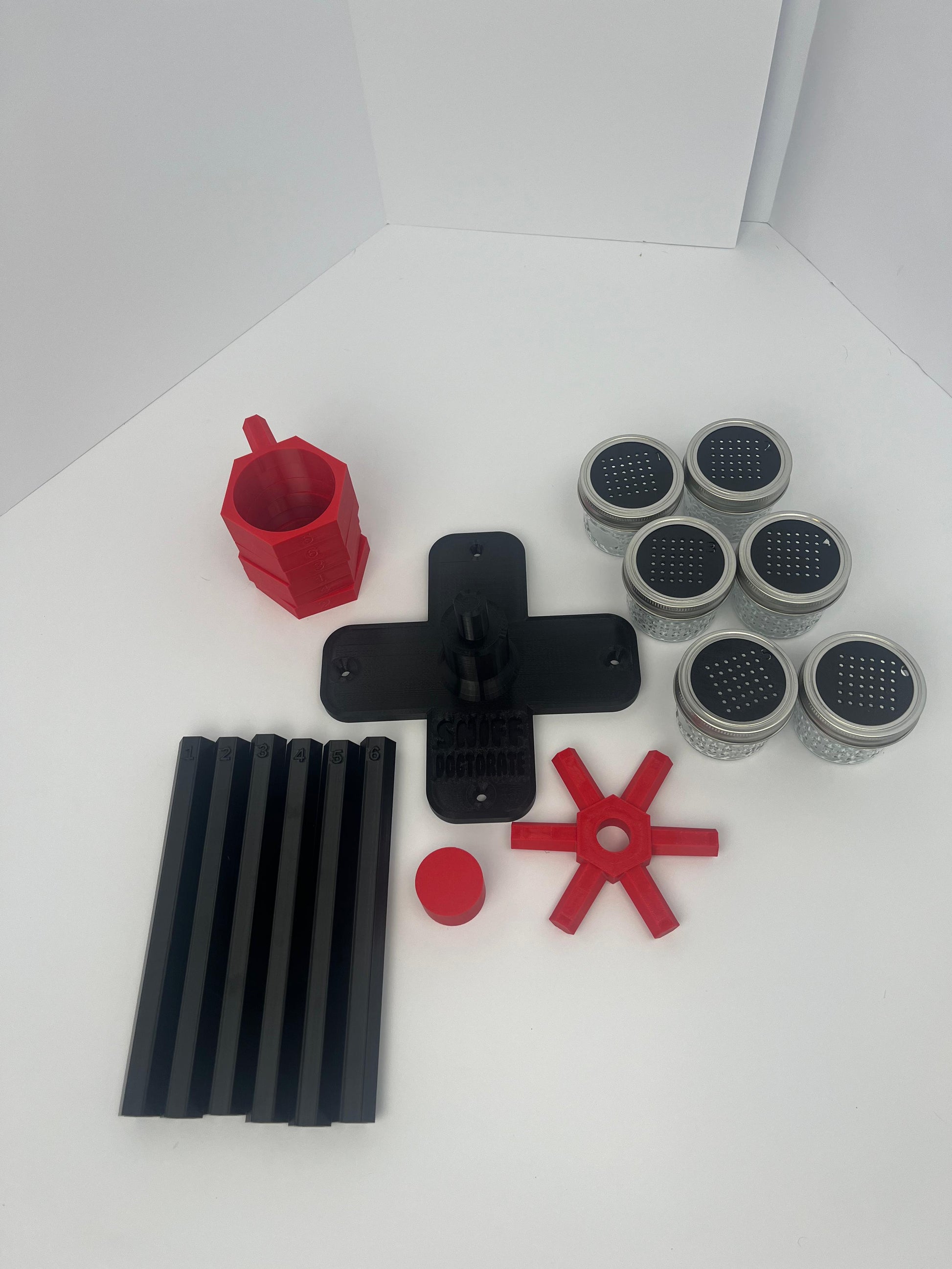 Large scent wheel with black base and arms, red spinner, topper, cup covers, and cup holders