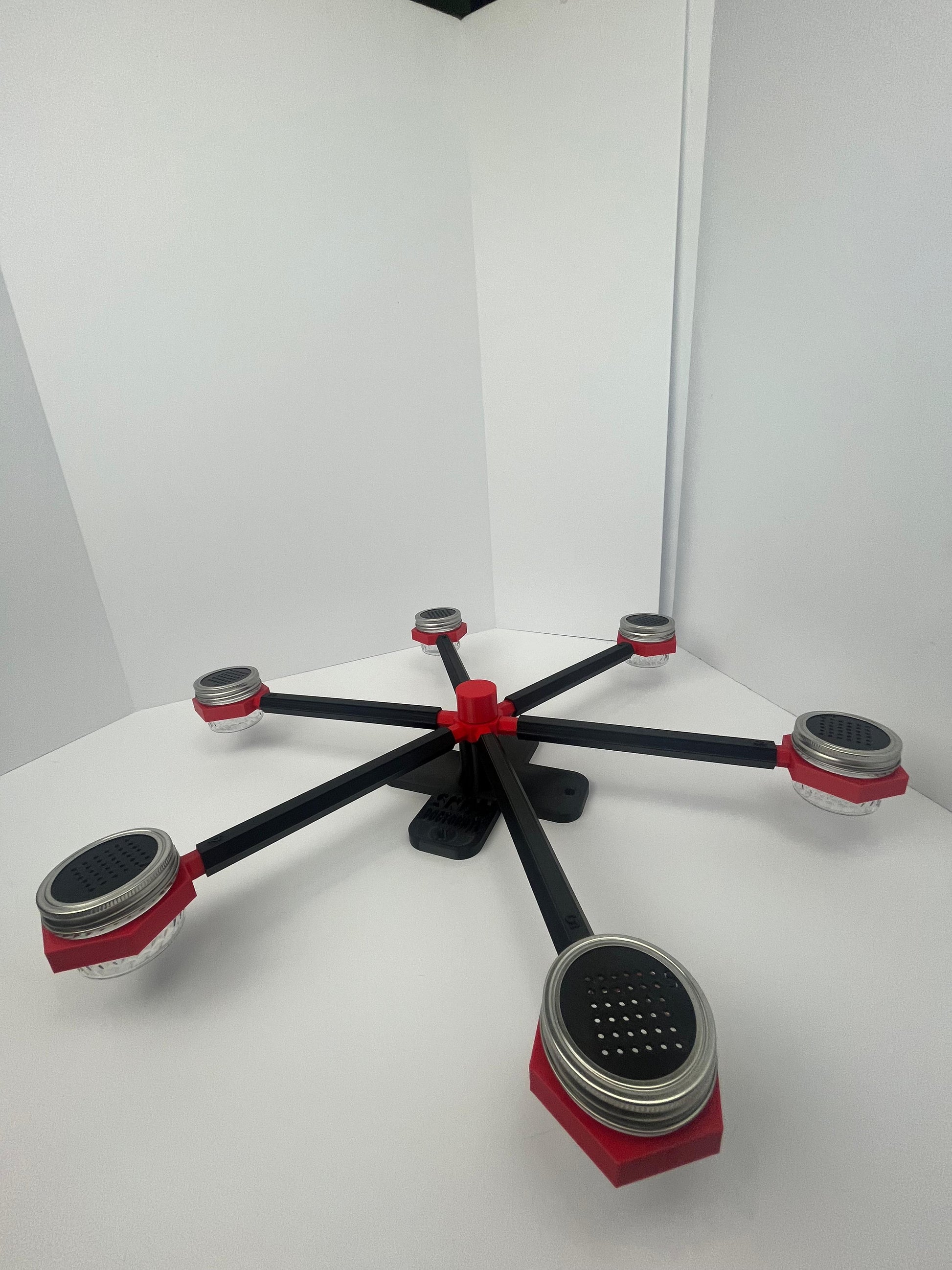 Large scent wheel with black base and arms, red spinner, topper, cup covers, and cup holders
