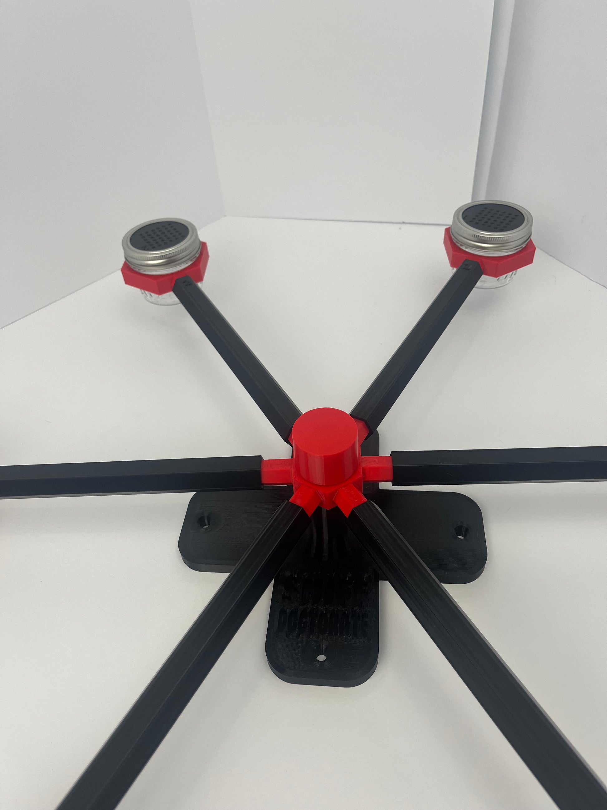 Large scent wheel with black base and arms, red spinner, topper, cup covers, and cup holders