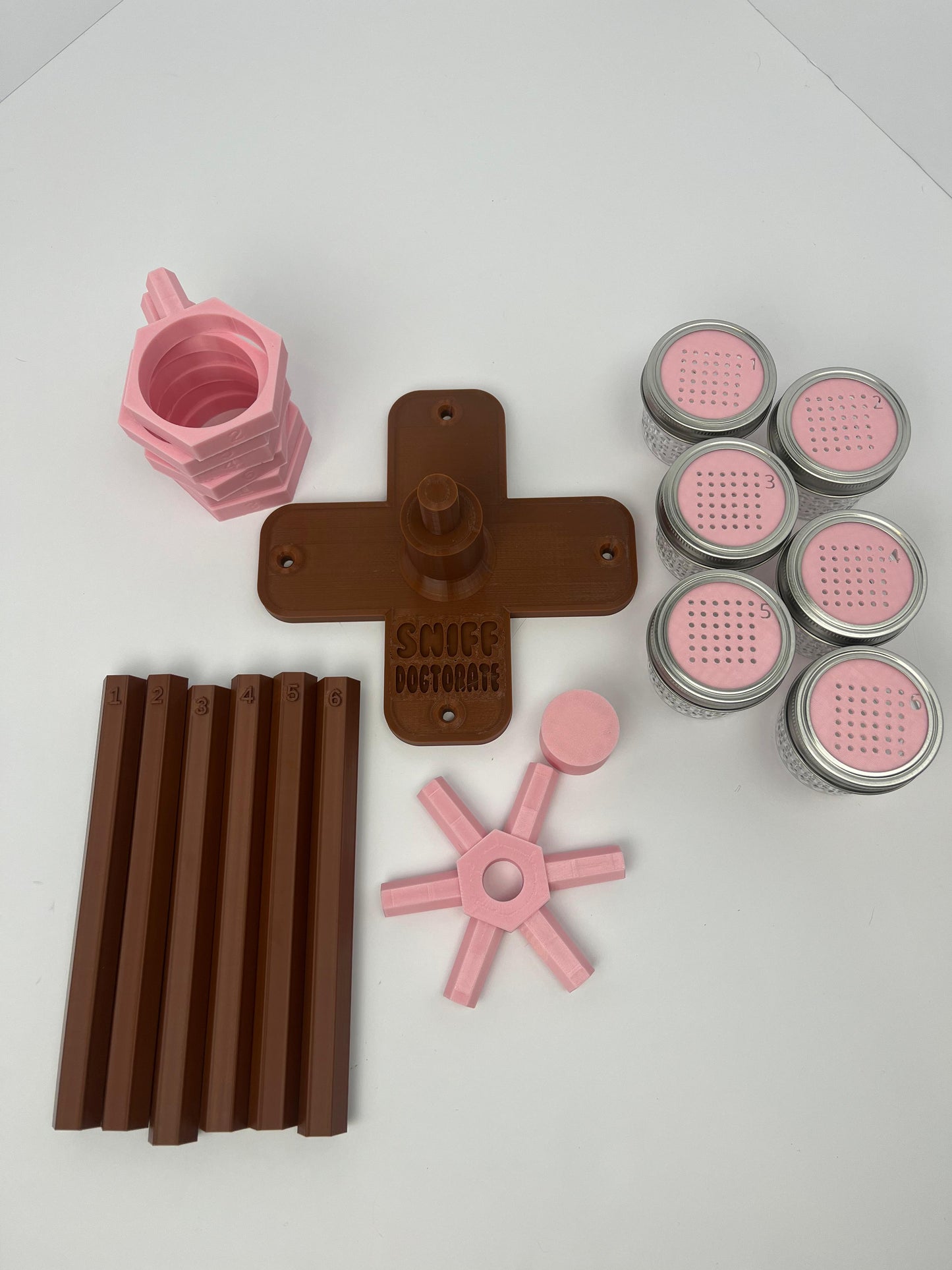 Large scent wheel with chocolate brown base and arms and sakura pink spinner, cup holders, cup covers, and base topper