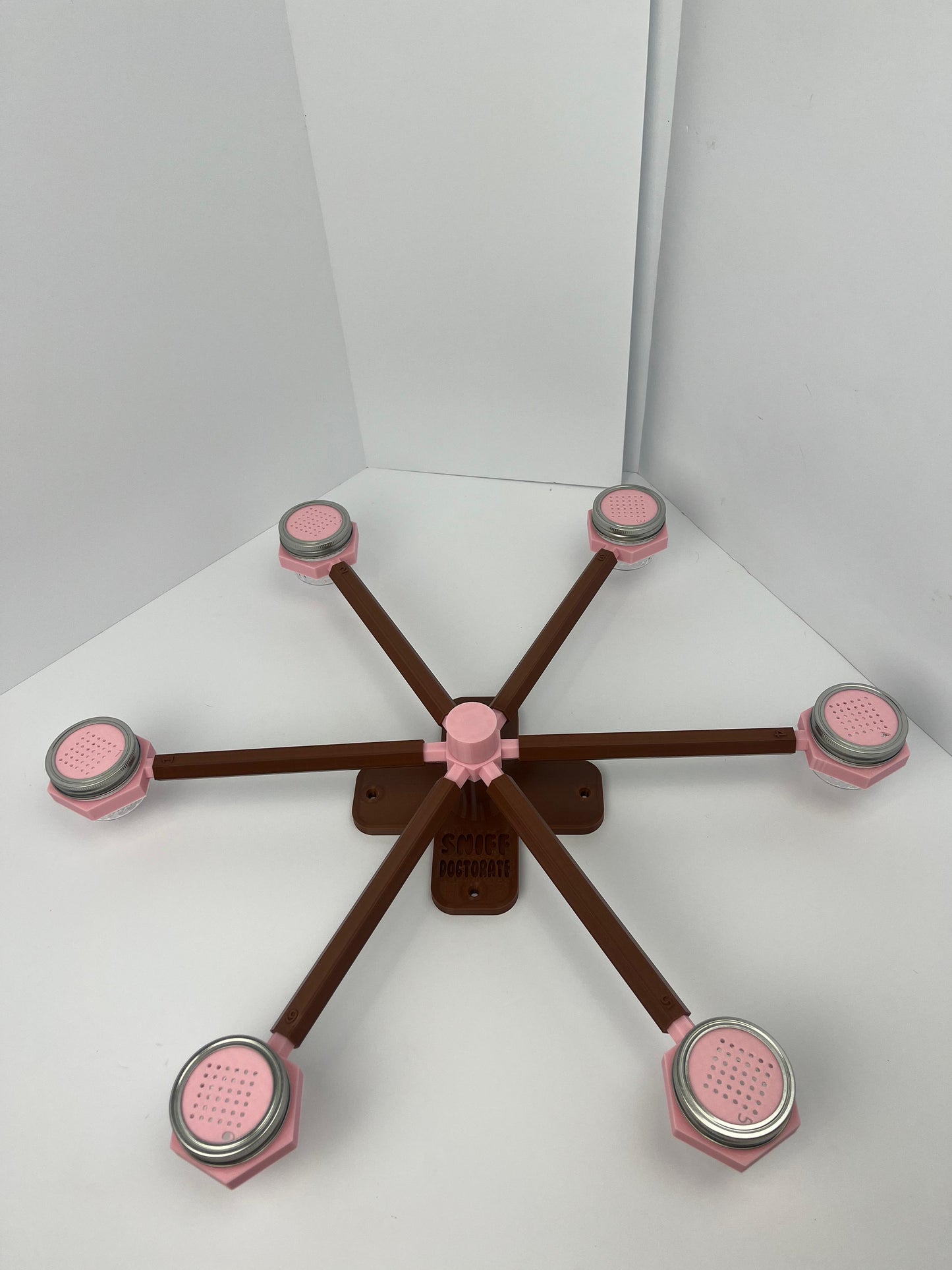 Large scent wheel with chocolate brown base and arms and sakura pink spinner, cup holders, cup covers, and base topper