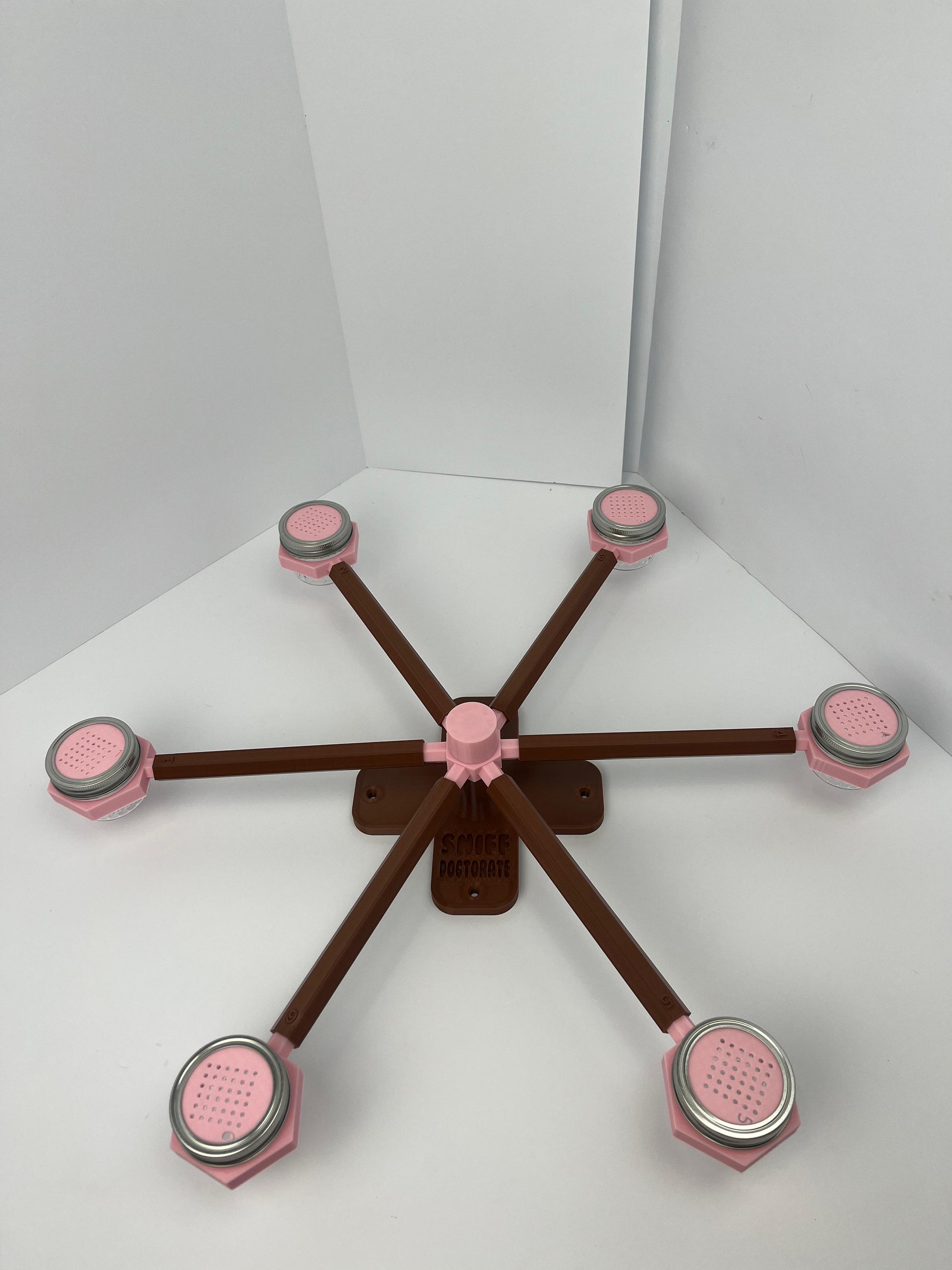 Large scent wheel with chocolate brown base and arms and sakura pink spinner, cup holders, cup covers, and base topper