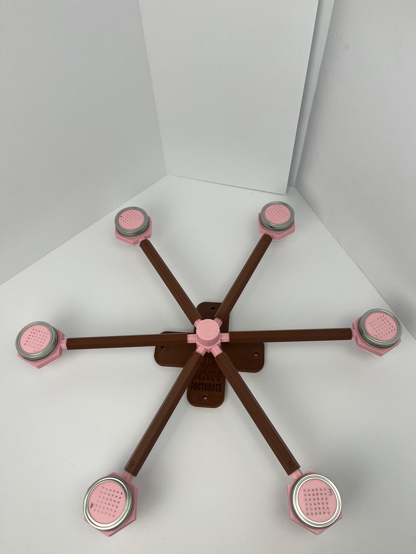Large scent wheel with chocolate brown base and arms and sakura pink spinner, cup holders, cup covers, and base topper