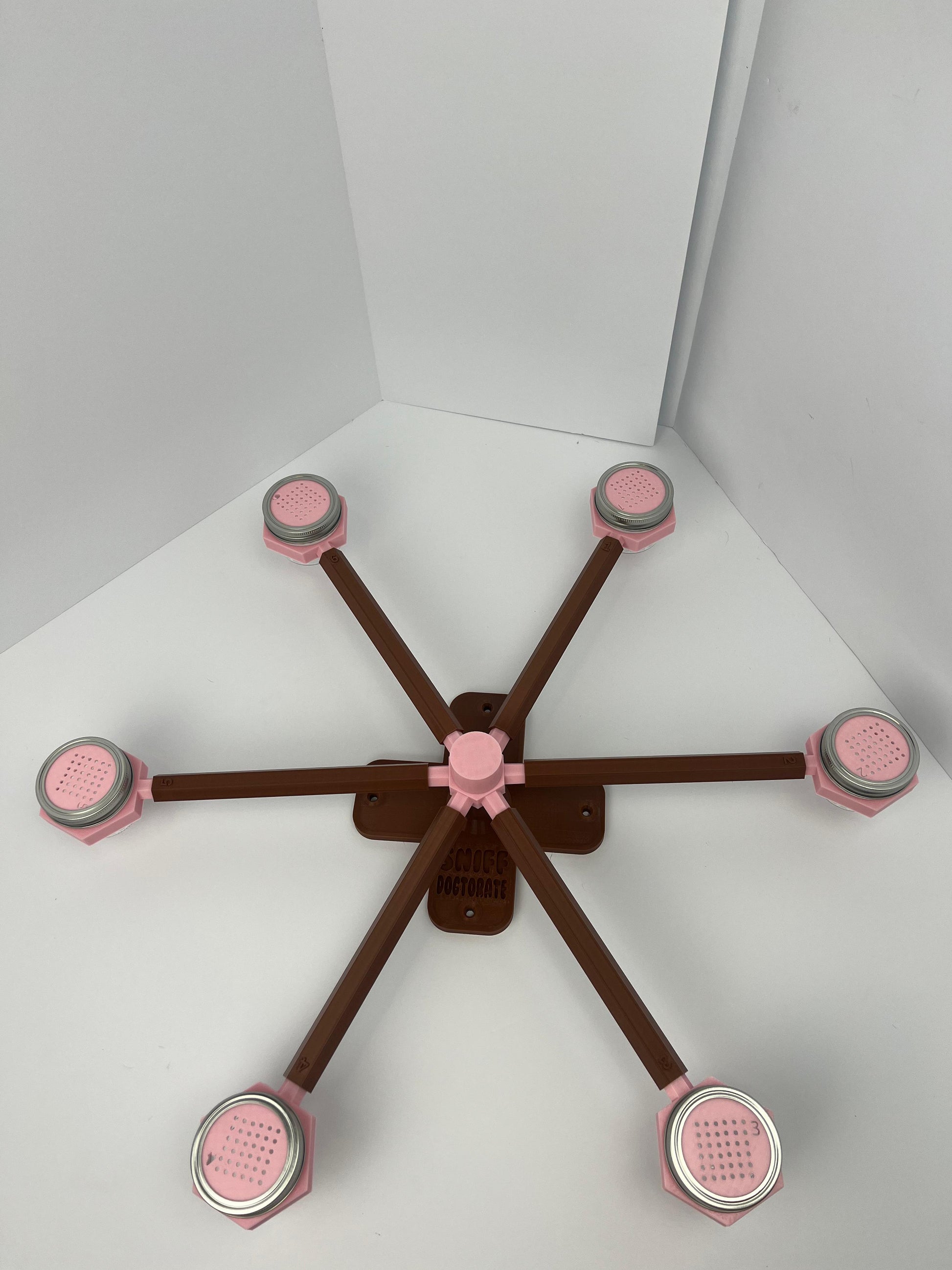 Large scent wheel with chocolate brown base and arms and sakura pink spinner, cup holders, cup covers, and base topper
