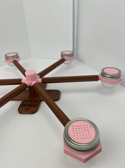 Large scent wheel with chocolate brown base and arms and sakura pink spinner, cup holders, cup covers, and base topper