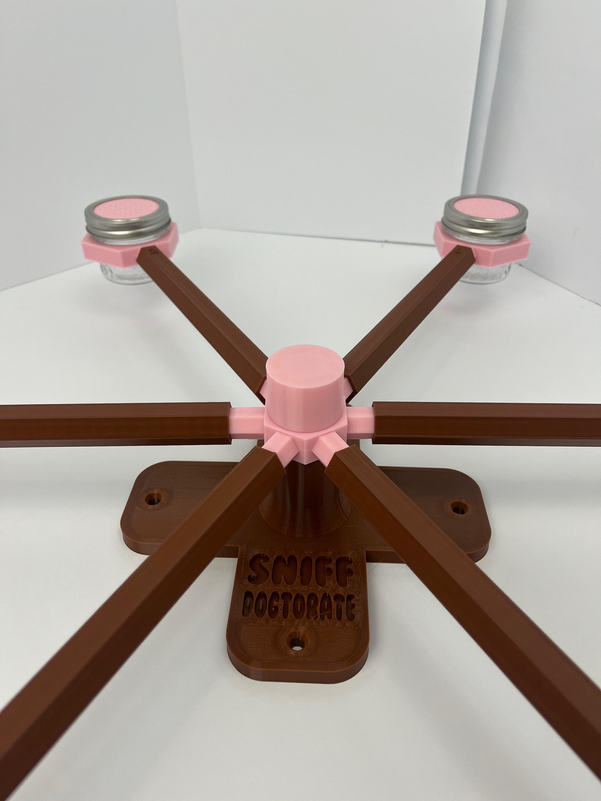 Large scent wheel with chocolate brown base and arms and sakura pink spinner, cup holders, cup covers, and base topper