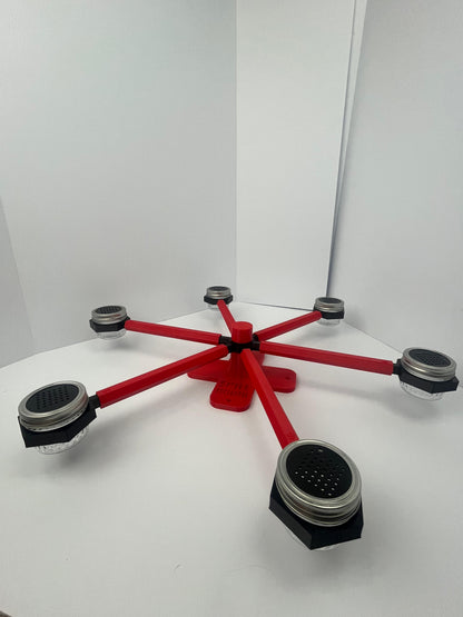 Large scent wheel with red base and arms and black spinner, cup holders, cup covers, and base topper