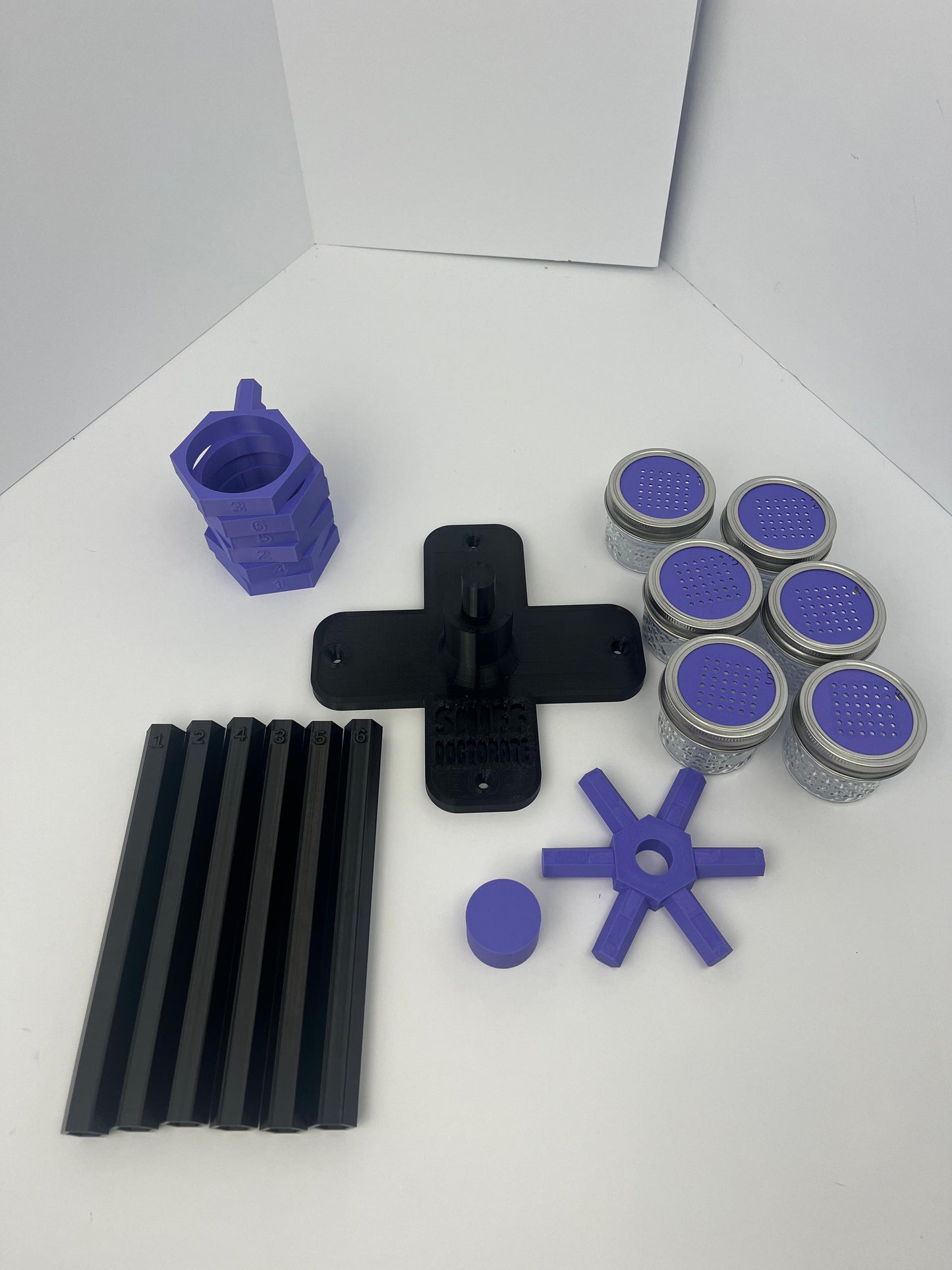 Large scent wheel with black base and arms, purple spinner, topper, cup covers, and cup holders