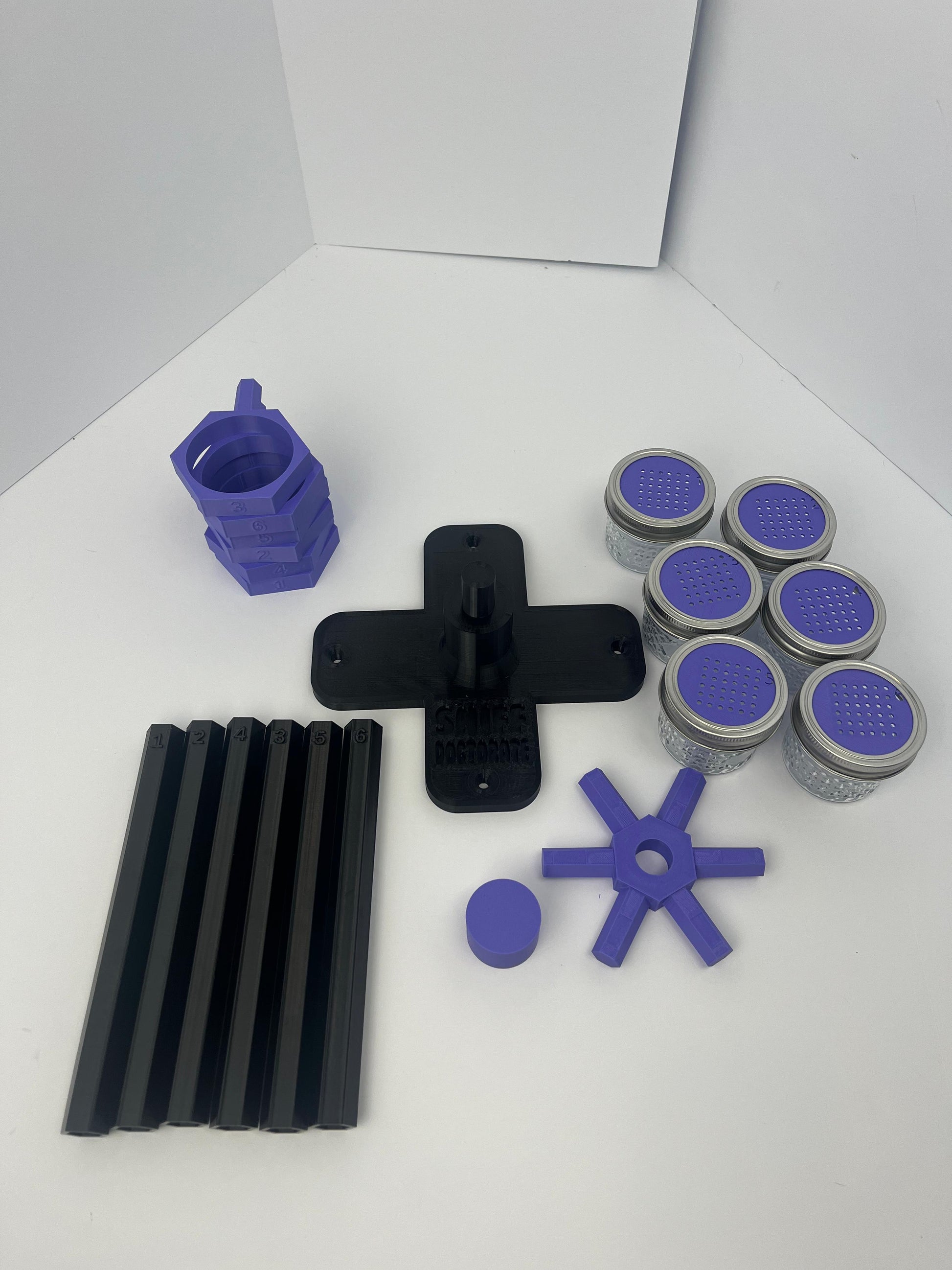Large scent wheel with black base and arms, purple spinner, topper, cup covers, and cup holders