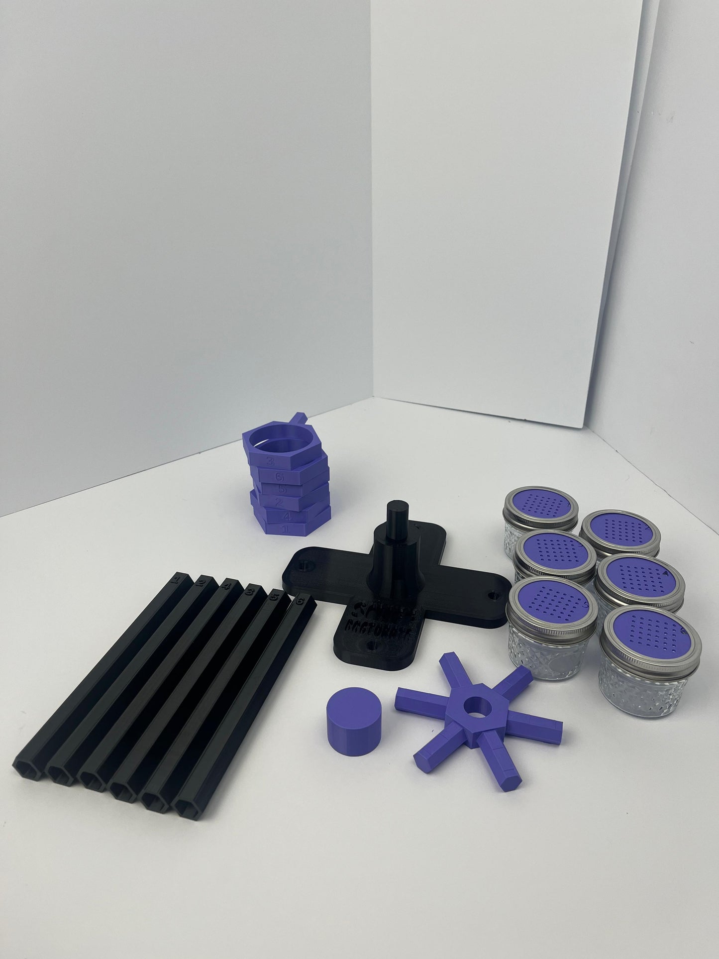 Large scent wheel with black base and arms, purple spinner, topper, cup covers, and cup holders