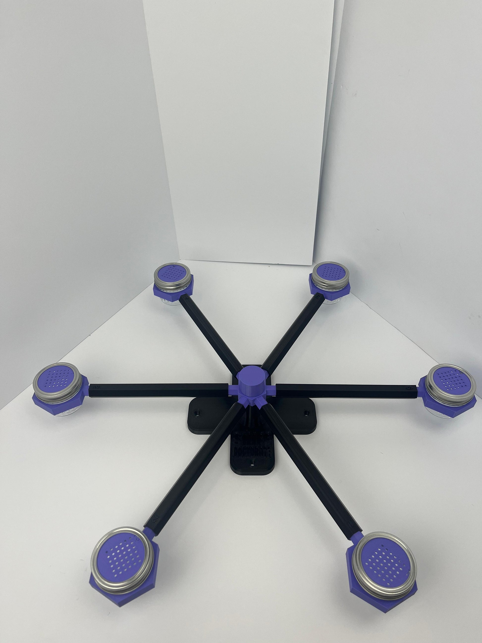 Large scent wheel with black base and arms, purple spinner, topper, cup covers, and cup holders