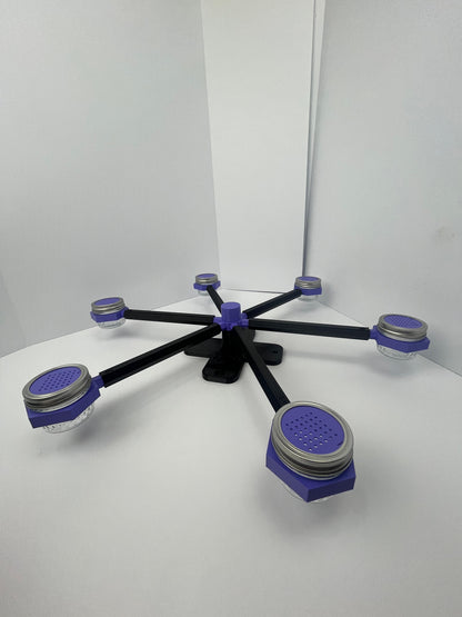 Large scent wheel with black base and arms, purple spinner, topper, cup covers, and cup holders