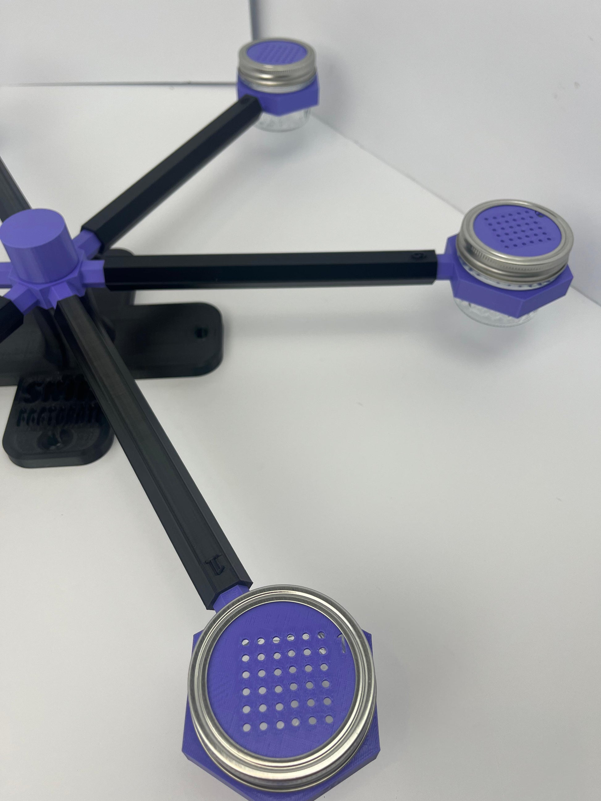 Large scent wheel with black base and arms, purple spinner, topper, cup covers, and cup holders