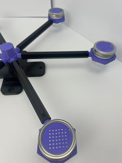 Large scent wheel with black base and arms, purple spinner, topper, cup covers, and cup holders