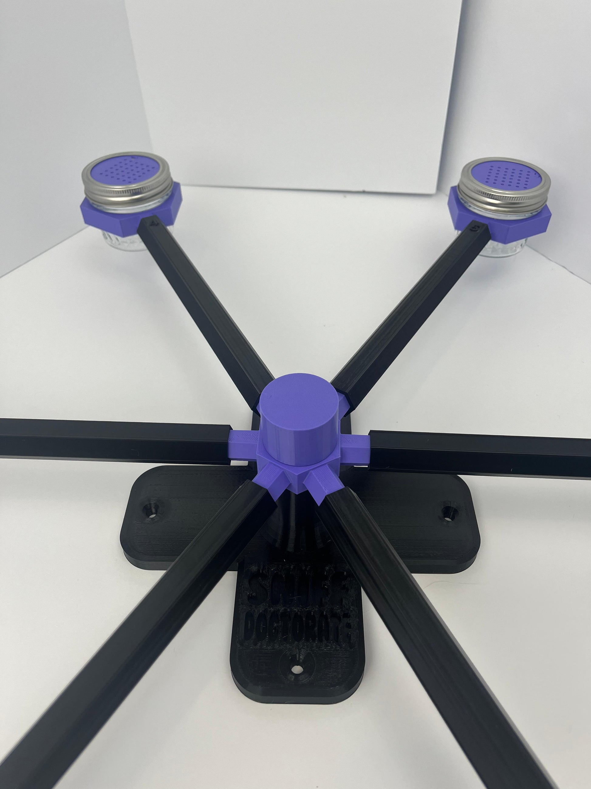 Large scent wheel with black base and arms, purple spinner, topper, cup covers, and cup holders